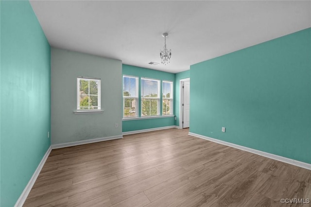 10485 Eagle Ct, Prince George, VA 23860 - unfurnished room featuring wood finished floors and a chandelier