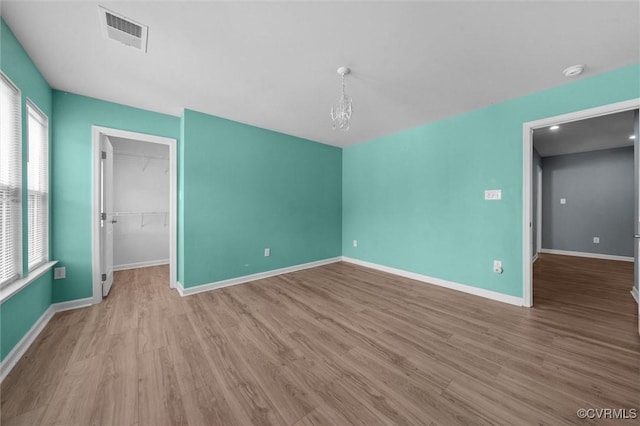 10485 Eagle Ct, Prince George, VA 23860 - spare room featuring wood finished floors, a chandelier, healthy amount of natural light, and a smoke detector