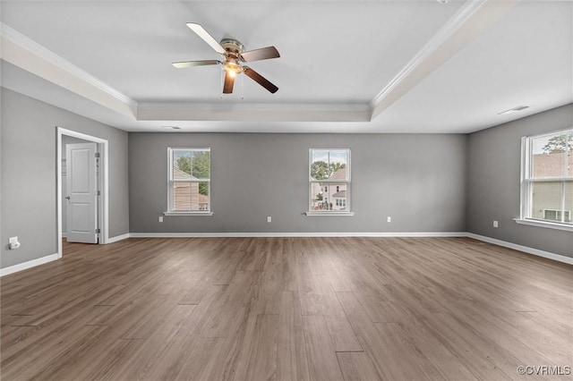 10485 Eagle Ct, Prince George, VA 23860 - unfurnished room featuring a tray ceiling, ornamental molding, plenty of natural light, and wood finished floors