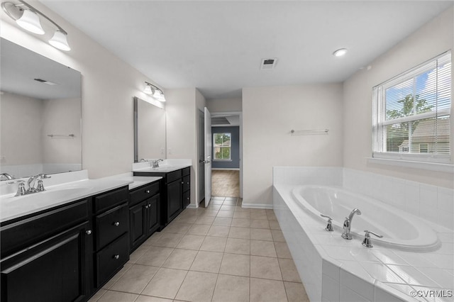 10485 Eagle Ct, Prince George, VA 23860 - full bathroom featuring double vanity, a bath, tile patterned flooring, and plenty of natural light