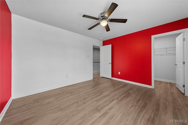 10485 Eagle Ct, Prince George, VA 23860 - unfurnished bedroom with wood finished floors, a spacious closet, and a ceiling fan