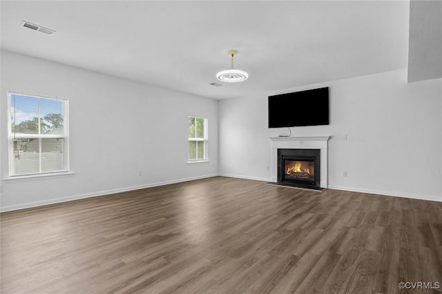 10485 Eagle Ct, Prince George, VA 23860 - unfurnished living room featuring wood finished floors and a fireplace with flush hearth