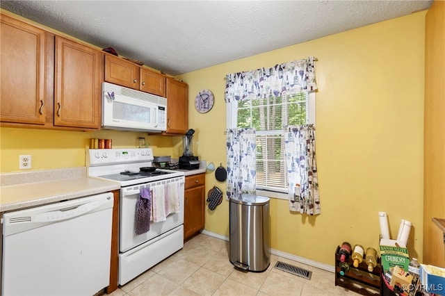 5564 Heatherhill Dr, North Chesterfield, VA 23234 - kitchen featuring white appliances, brown cabinets, light countertops, light tile patterned flooring, and a textured ceiling
