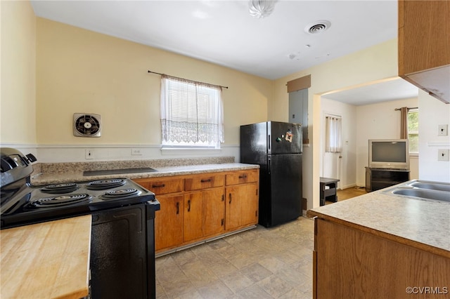 125 Seaboard St, Petersburg, VA 23803 - kitchen with black appliances, light countertops, and brown cabinets