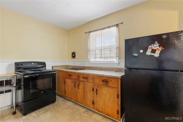 125 Seaboard St, Petersburg, VA 23803 - kitchen featuring black appliances, light countertops, and brown cabinets