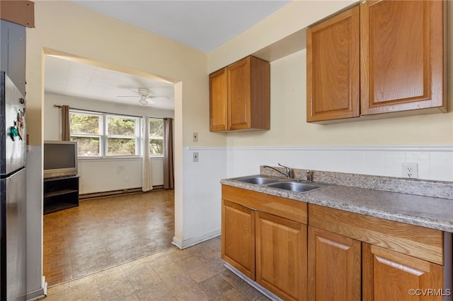 125 Seaboard St, Petersburg, VA 23803 - kitchen featuring freestanding refrigerator, brown cabinetry, ceiling fan, and light countertops