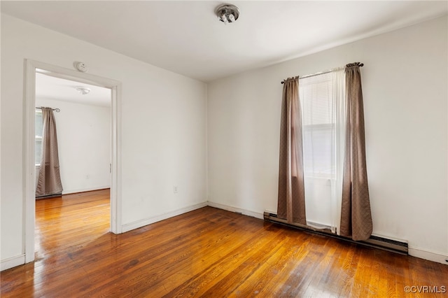 125 Seaboard St, Petersburg, VA 23803 - unfurnished room featuring baseboard heating, hardwood / wood-style floors, and a smoke detector