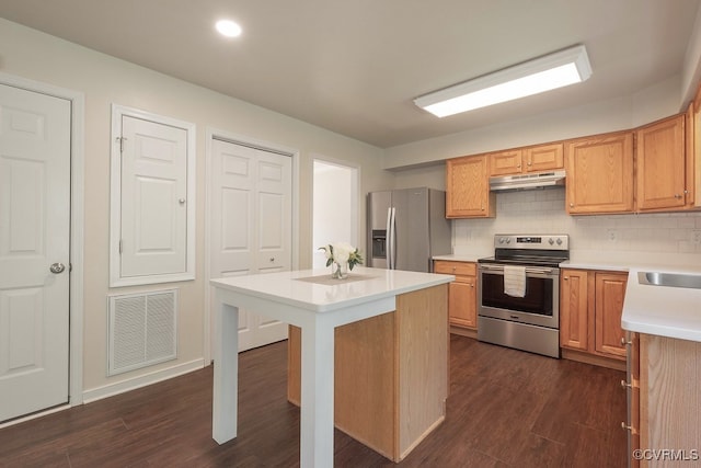 5636 Charter Oak Dr, Chesterfield, VA 23832 - kitchen featuring appliances with stainless steel finishes, under cabinet range hood, light countertops, dark wood-style floors, and recessed lighting