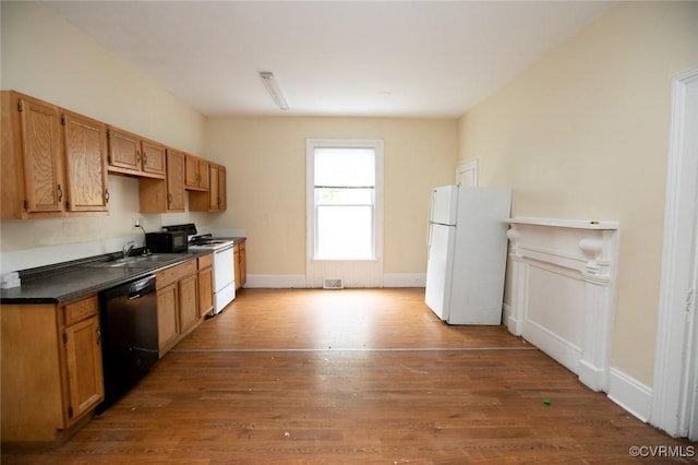 410 E 2nd St, Farmville, VA 23901 - kitchen with white appliances, wood finished floors, and dark countertops