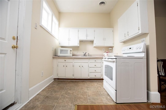 410 E 2nd St, Farmville, VA 23901 - kitchen with white appliances, white cabinets, and light countertops