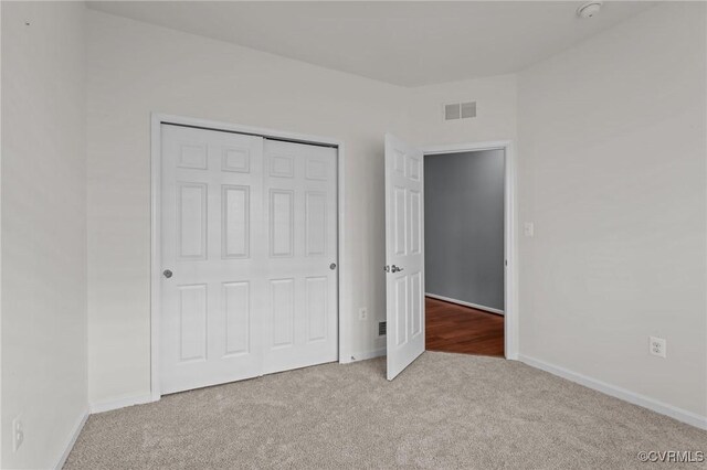 8334 E Lord Botetourt Loop, New Kent, VA 23124 - unfurnished bedroom featuring carpet floors and a closet