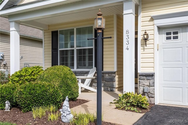 8334 E Lord Botetourt Loop, New Kent, VA 23124 - entrance to property featuring a porch, stone siding, and a garage