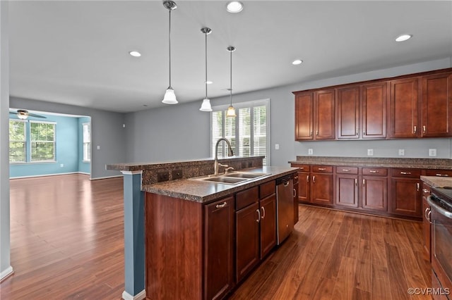 8334 E Lord Botetourt Loop, New Kent, VA 23124 - kitchen featuring dark countertops, healthy amount of natural light, dark wood-style flooring, an island with sink, and recessed lighting