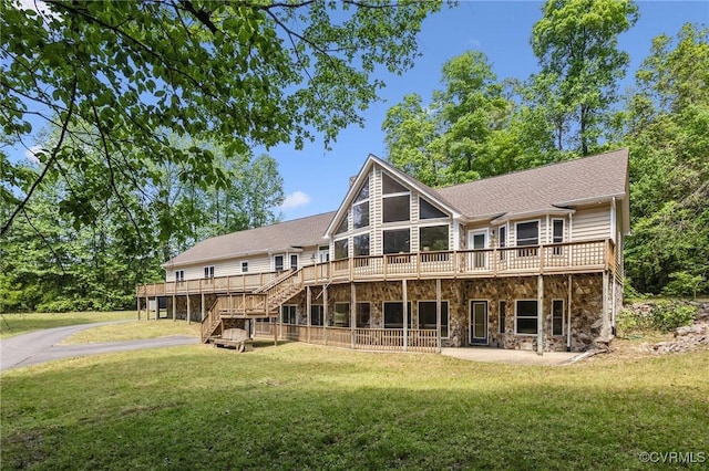 6002 Prospectors Bluff Ln, Mechanicsville, VA 23116 - rear view of house with stone siding, a deck, stairway, and a yard