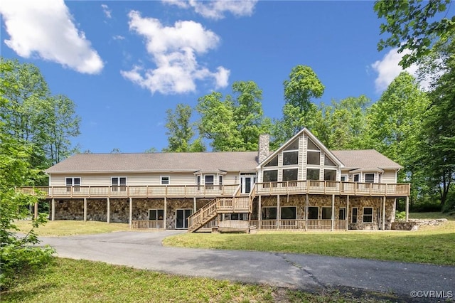 6002 Prospectors Bluff Ln, Mechanicsville, VA 23116 - back of property featuring stone siding, asphalt driveway, a wooden deck, a chimney, and a yard
