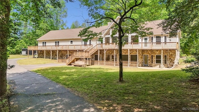 6002 Prospectors Bluff Ln, Mechanicsville, VA 23116 - rear view of property featuring stone siding, a lawn, stairs, and a wooden deck