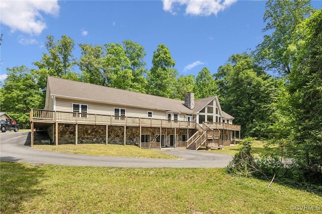 6002 Prospectors Bluff Ln, Mechanicsville, VA 23116 - back of house featuring a deck, a yard, a chimney, stairs, and driveway