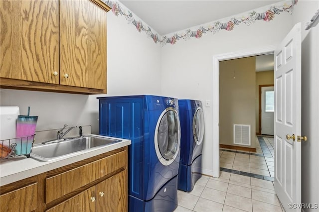 6002 Prospectors Bluff Ln, Mechanicsville, VA 23116 - laundry room with washing machine and dryer, cabinet space, and light tile patterned flooring