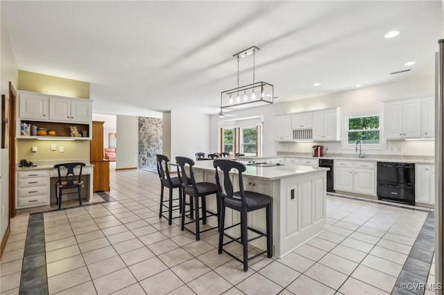 6002 Prospectors Bluff Ln, Mechanicsville, VA 23116 - kitchen with light tile patterned floors, dishwasher, a breakfast bar area, white cabinets, and a center island