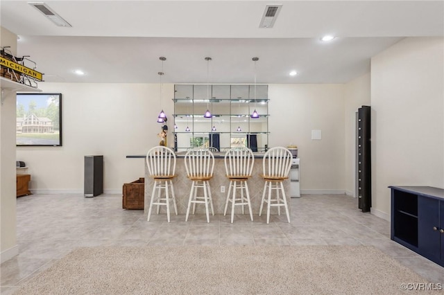 6002 Prospectors Bluff Ln, Mechanicsville, VA 23116 - kitchen with recessed lighting, a kitchen breakfast bar, hanging light fixtures, and light tile patterned floors