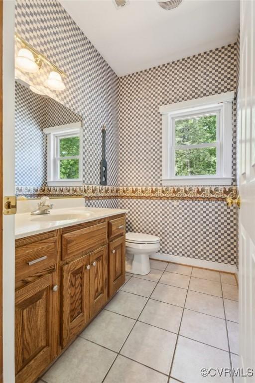 6002 Prospectors Bluff Ln, Mechanicsville, VA 23116 - bathroom featuring vanity, wallpapered walls, tile patterned flooring, and tile walls