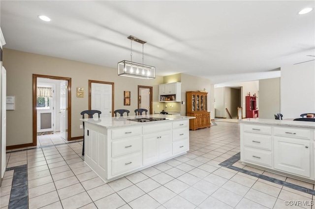 6002 Prospectors Bluff Ln, Mechanicsville, VA 23116 - kitchen featuring light tile patterned flooring, black electric stovetop, white cabinetry, hanging light fixtures, and a center island