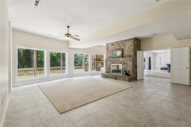 6002 Prospectors Bluff Ln, Mechanicsville, VA 23116 - unfurnished living room featuring a ceiling fan, a stone fireplace, and light tile patterned flooring