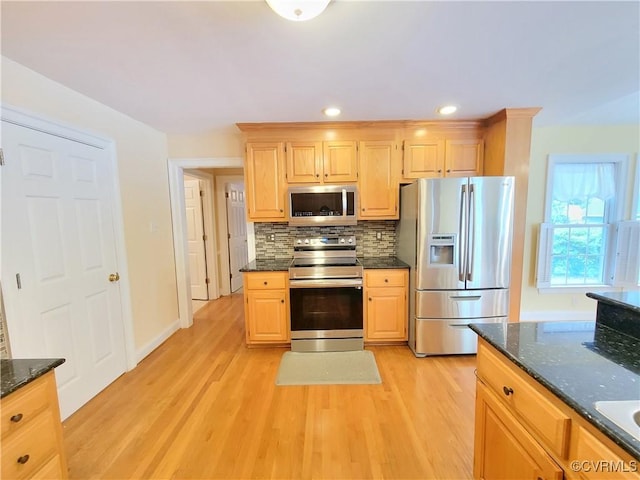 231 White Sand Ct, Colonial Heights, VA 23834 - kitchen with stainless steel appliances, light brown cabinets, decorative backsplash, light wood-style flooring, and dark stone counters