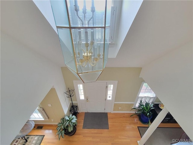 231 White Sand Ct, Colonial Heights, VA 23834 - entryway with a chandelier, wood finished floors, and a towering ceiling