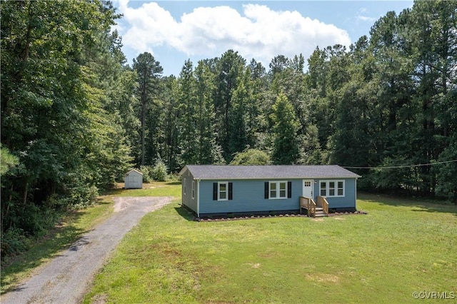 22805 Carson Rd, Carson, VA 23841 - view of front facade with gravel driveway, a shed, a front lawn, and a view of trees