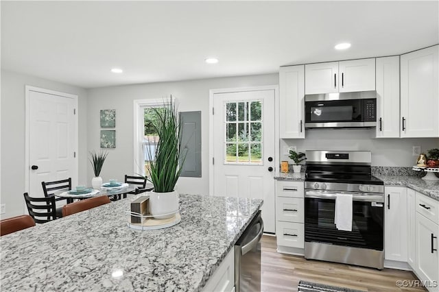 22805 Carson Rd, Carson, VA 23841 - kitchen with stainless steel appliances, white cabinets, light stone counters, light wood-style flooring, and recessed lighting