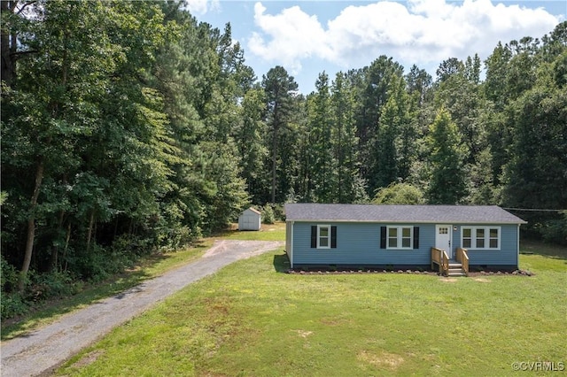 22805 Carson Rd, Carson, VA 23841 - view of front of home with driveway, a storage unit, crawl space, a front yard, and a view of trees