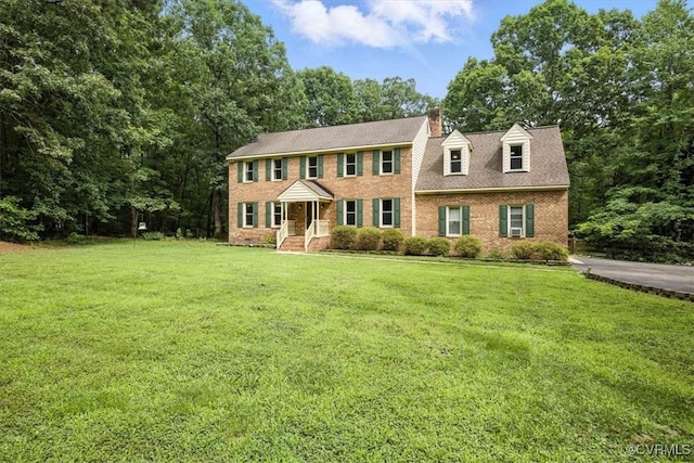 13241 Bailey Bridge Rd, North Chesterfield, VA 23112 - colonial inspired home featuring a front lawn, a chimney, and brick siding