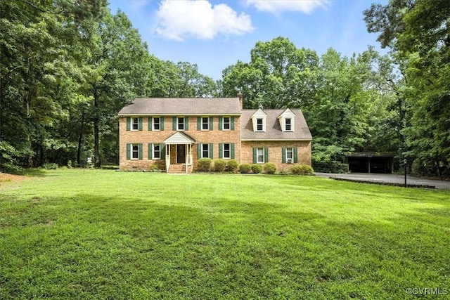 13241 Bailey Bridge Rd, North Chesterfield, VA 23112 - colonial inspired home with a front yard, driveway, a detached carport, and view of scattered trees