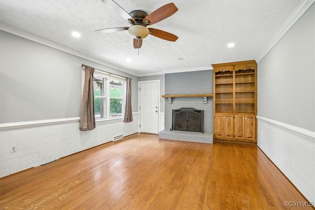 13241 Bailey Bridge Rd, North Chesterfield, VA 23112 - unfurnished living room with a fireplace, a textured ceiling, wood finished floors, ceiling fan, and wainscoting