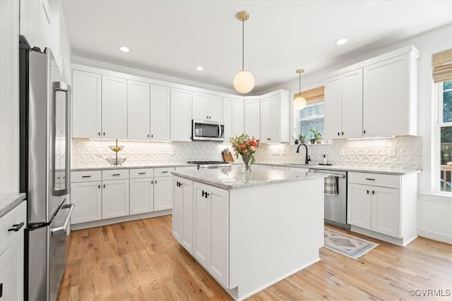 1450 Palmore Rd, Powhatan, VA 23139 - kitchen featuring stainless steel appliances, white cabinets, decorative backsplash, light wood-type flooring, and recessed lighting