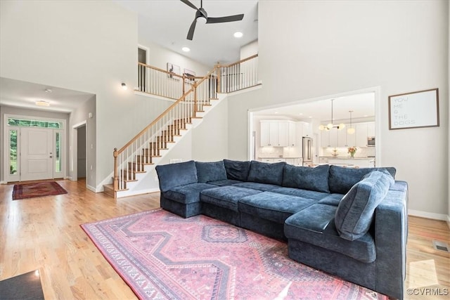 1450 Palmore Rd, Powhatan, VA 23139 - living room with a towering ceiling, stairs, a ceiling fan, light wood finished floors, and recessed lighting