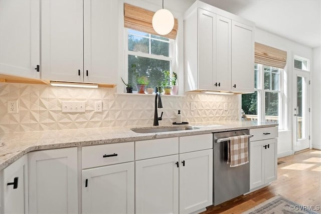 1450 Palmore Rd, Powhatan, VA 23139 - kitchen featuring stainless steel dishwasher, white cabinets, light wood-style floors, light stone countertops, and decorative backsplash