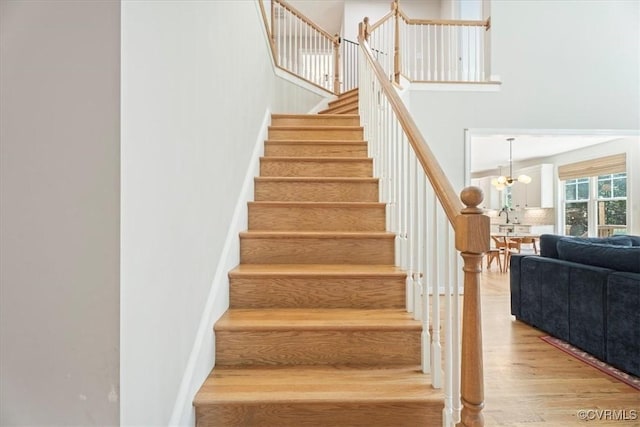 1450 Palmore Rd, Powhatan, VA 23139 - staircase with wood finished floors, a high ceiling, and a chandelier