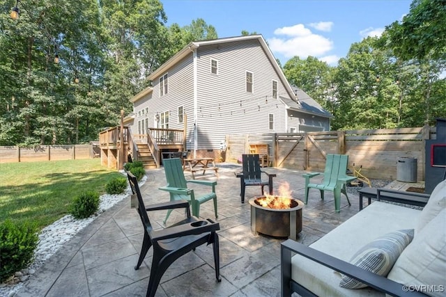 1450 Palmore Rd, Powhatan, VA 23139 - fenced backyard featuring a fire pit, stairway, a patio area, and a wooden deck