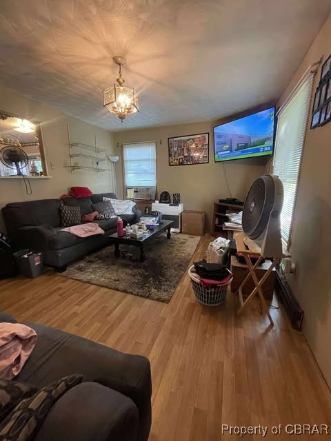 4487 Tidewater Trl, Jamaica, VA 23079 - living room featuring wood finished floors and a chandelier