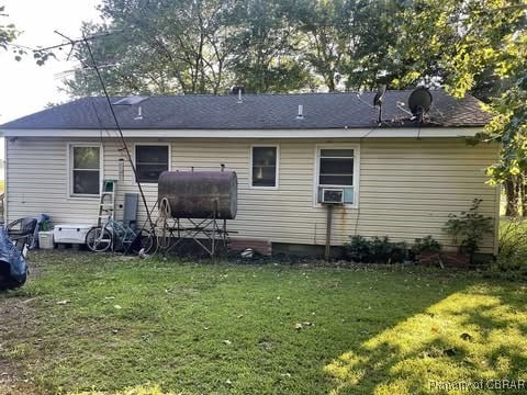 4487 Tidewater Trl, Jamaica, VA 23079 - rear view of house featuring heating fuel, a lawn, and cooling unit