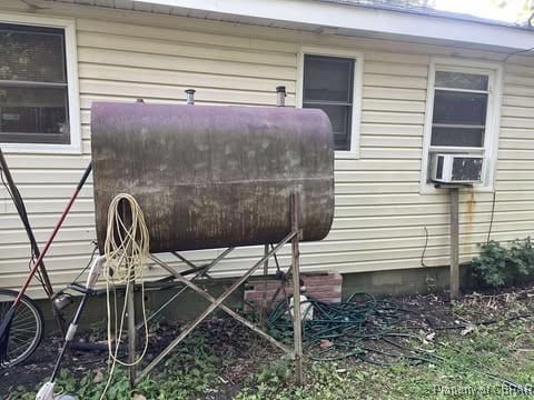 4487 Tidewater Trl, Jamaica, VA 23079 - view of home's exterior with heating fuel, cooling unit, and crawl space