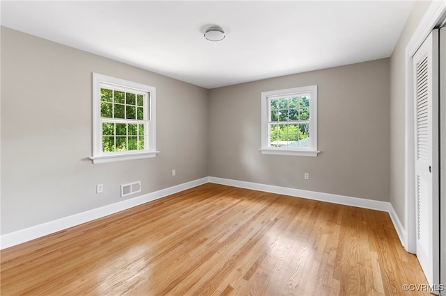 4816 Stornoway Dr, Ampthill, VA 23234 - unfurnished bedroom with multiple windows, a closet, and light wood-type flooring