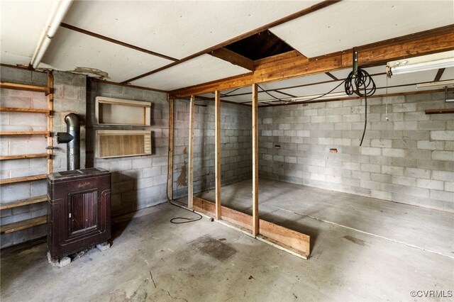 4816 Stornoway Dr, Ampthill, VA 23234 - unfinished below grade area with a wood stove and concrete block wall