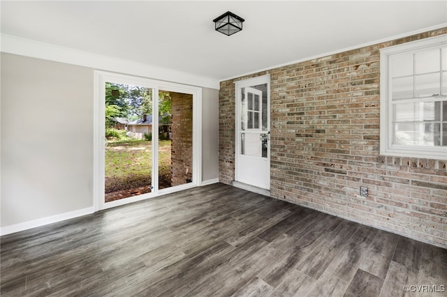 4816 Stornoway Dr, Ampthill, VA 23234 - empty room with brick wall, dark wood-type flooring, and crown molding