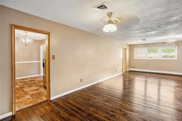 2407 Birchwood Rd, Henrico, VA 23294 - unfurnished room with a chandelier, a baseboard heating unit, wood finished floors, and a textured ceiling