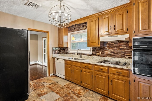 2407 Birchwood Rd, Henrico, VA 23294 - kitchen with stainless steel appliances, under cabinet range hood, a chandelier, decorative backsplash, and hanging light fixtures