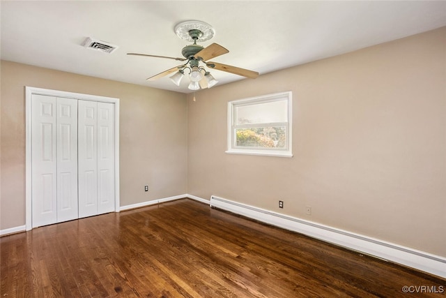 2407 Birchwood Rd, Henrico, VA 23294 - unfurnished bedroom with baseboard heating, wood finished floors, a closet, and ceiling fan