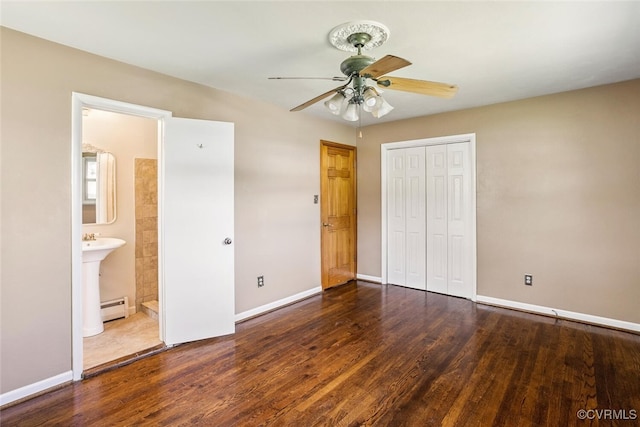 2407 Birchwood Rd, Henrico, VA 23294 - unfurnished bedroom featuring baseboard heating, wood finished floors, a closet, and a ceiling fan